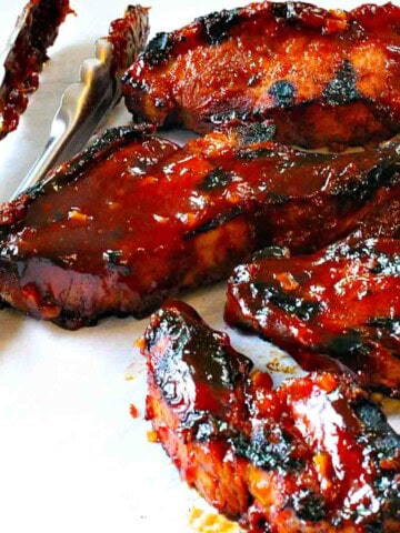Grilled country style pork ribs with BBQ sauce.