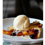 peach blueberry pie with lattice topping and ice cream
