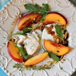 Grilled peach salad with arugula and burrata cheese.