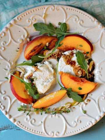 Grilled peach salad with arugula and burrata cheese.