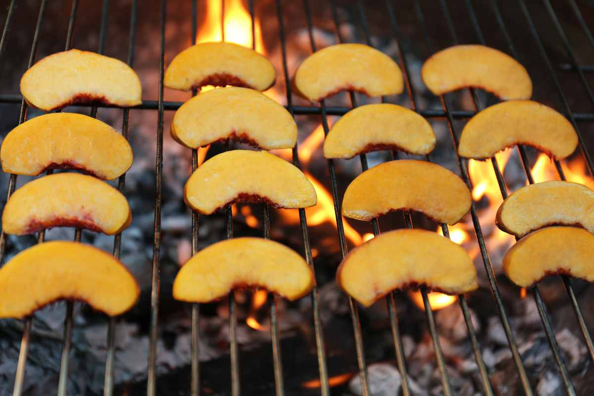 Grilling peach slices for grilled peach salad.