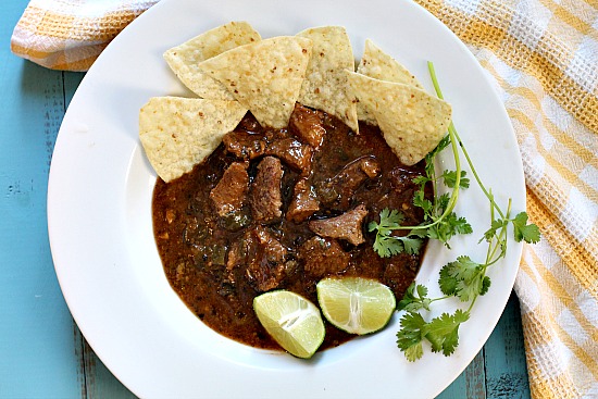 Beef chuck chile recipe in a white bowl with lime and cilantro