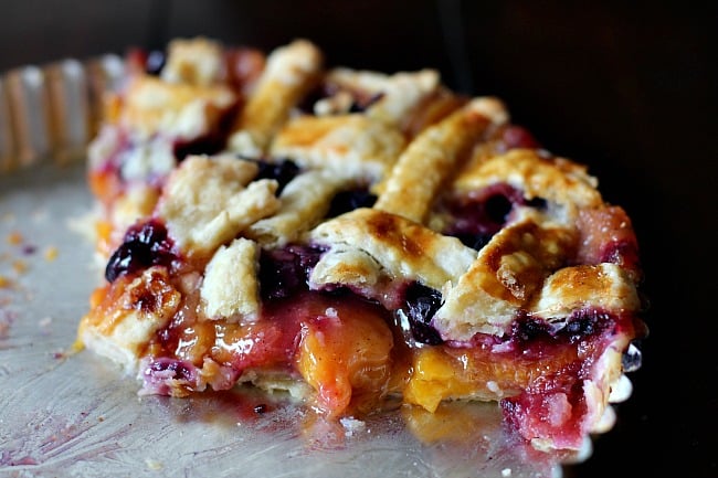 Peach blueberry pie in a 9" tart pan with lattice topping.