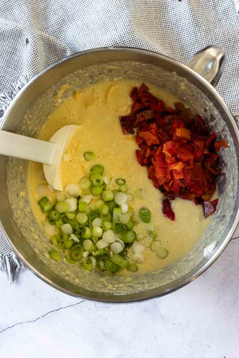 Mixing eggs and cheese together to make an Italian Breakfast Casserole.