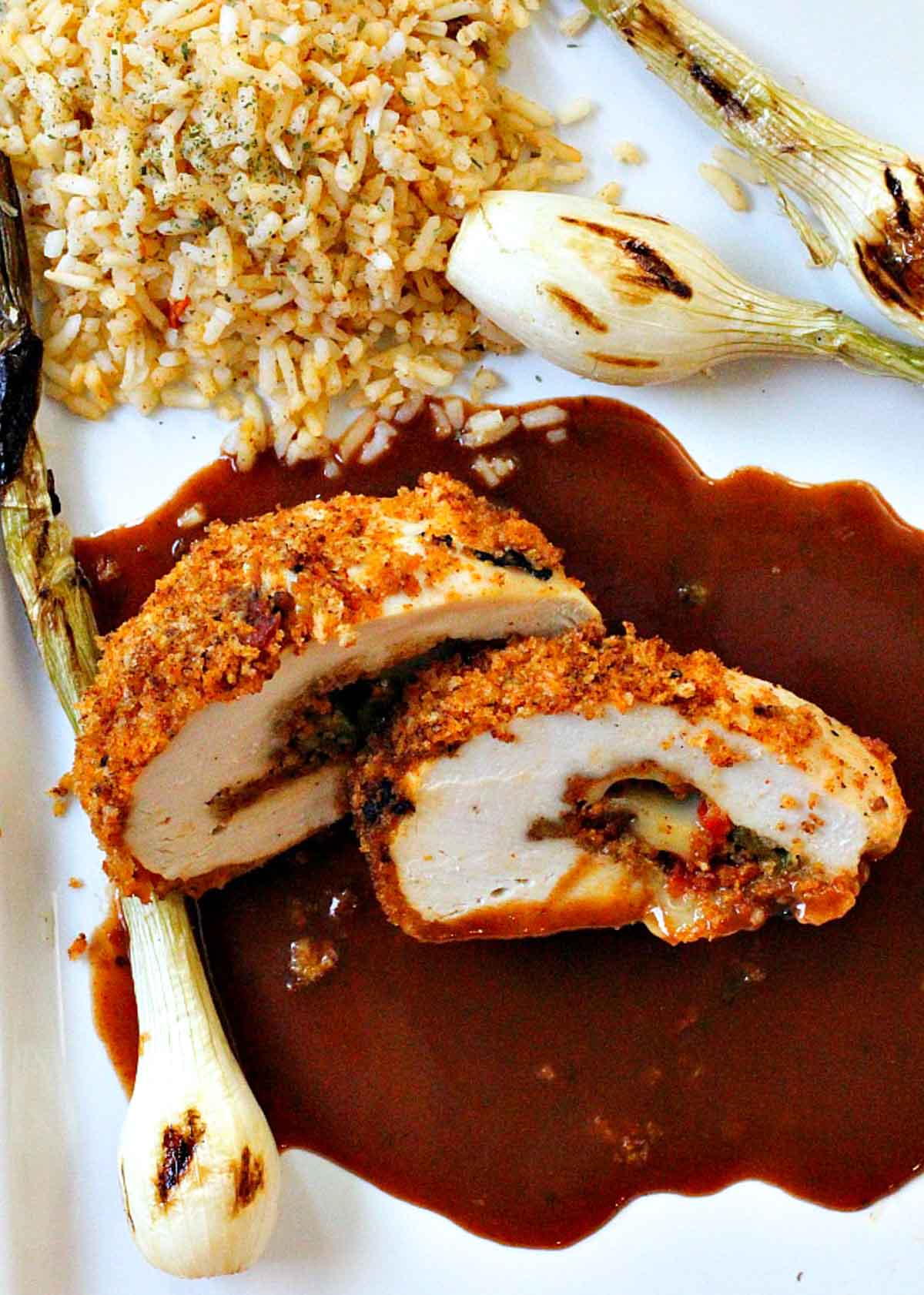 Chorizo cheese stuffed chicken breast served with rice and grilled knob onions.