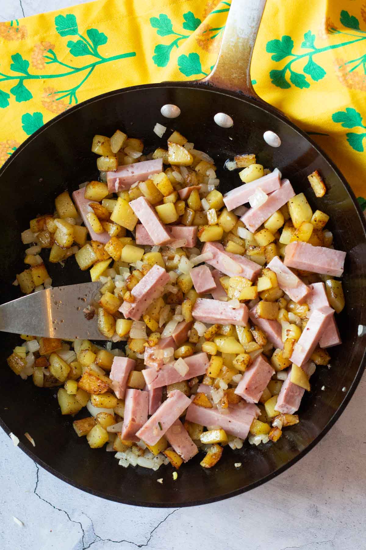 Skillet potatoes with onions and chunks of ham.
