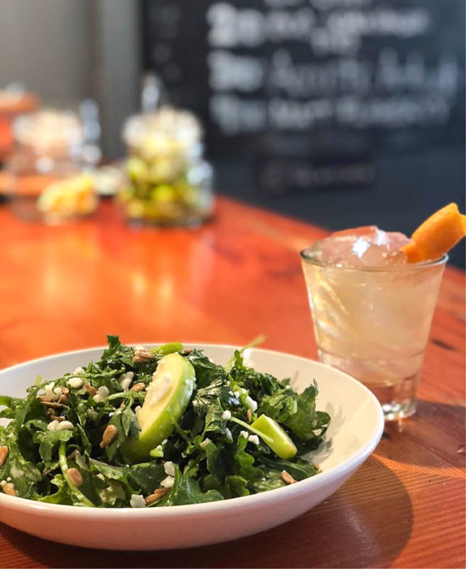 Baby Kale Salad served with a cocktail.