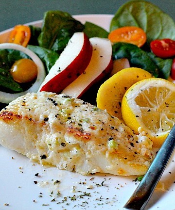 Baked Halibut Recipe topped with mayonnaise and served with a side salad