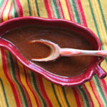 Best homemade enchilada sauce in a chile pepper shaped bowl.