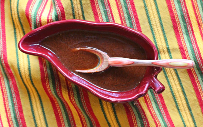 Best homemade enchilada sauce in a chile pepper shaped bowl.