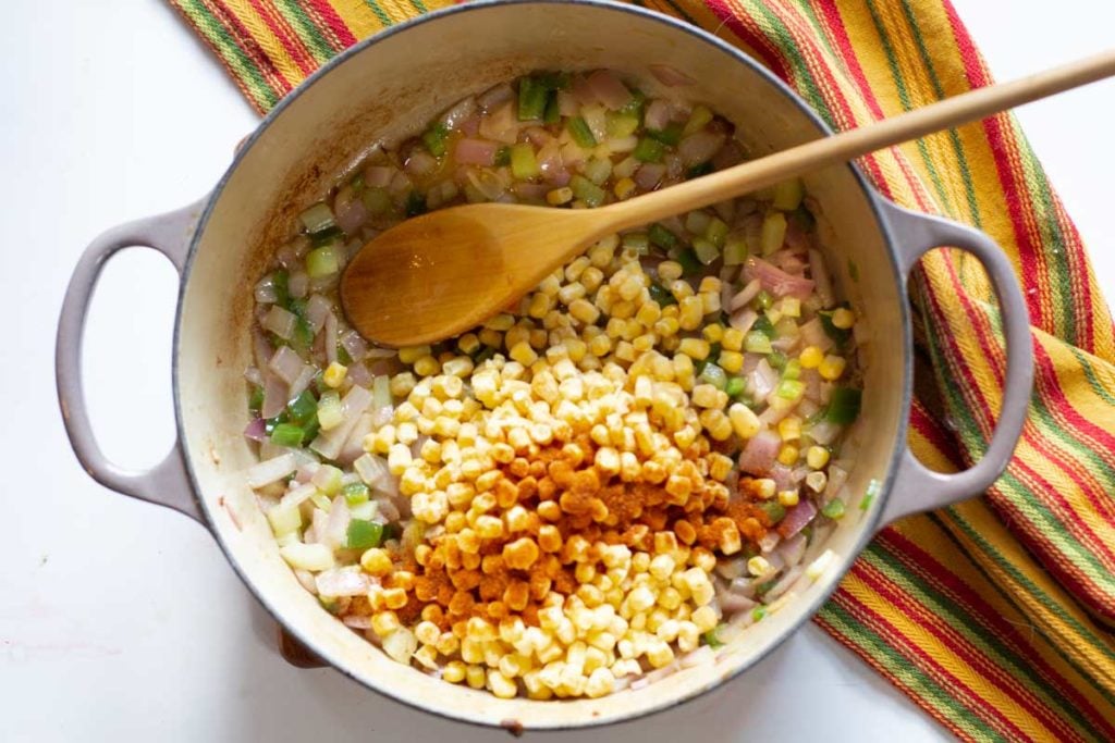 Adding corn and seasoning to make chorizo stuffing