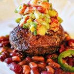 Pan seared filet mignon topped with lobster salsa and served over beans.