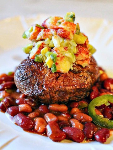 Pan seared filet mignon topped with lobster salsa and served over beans.