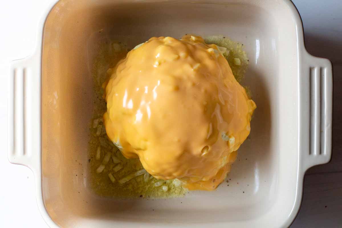 Whole cauliflower thats been cooked in the microwave topped with a mayonnaise cheese sauce