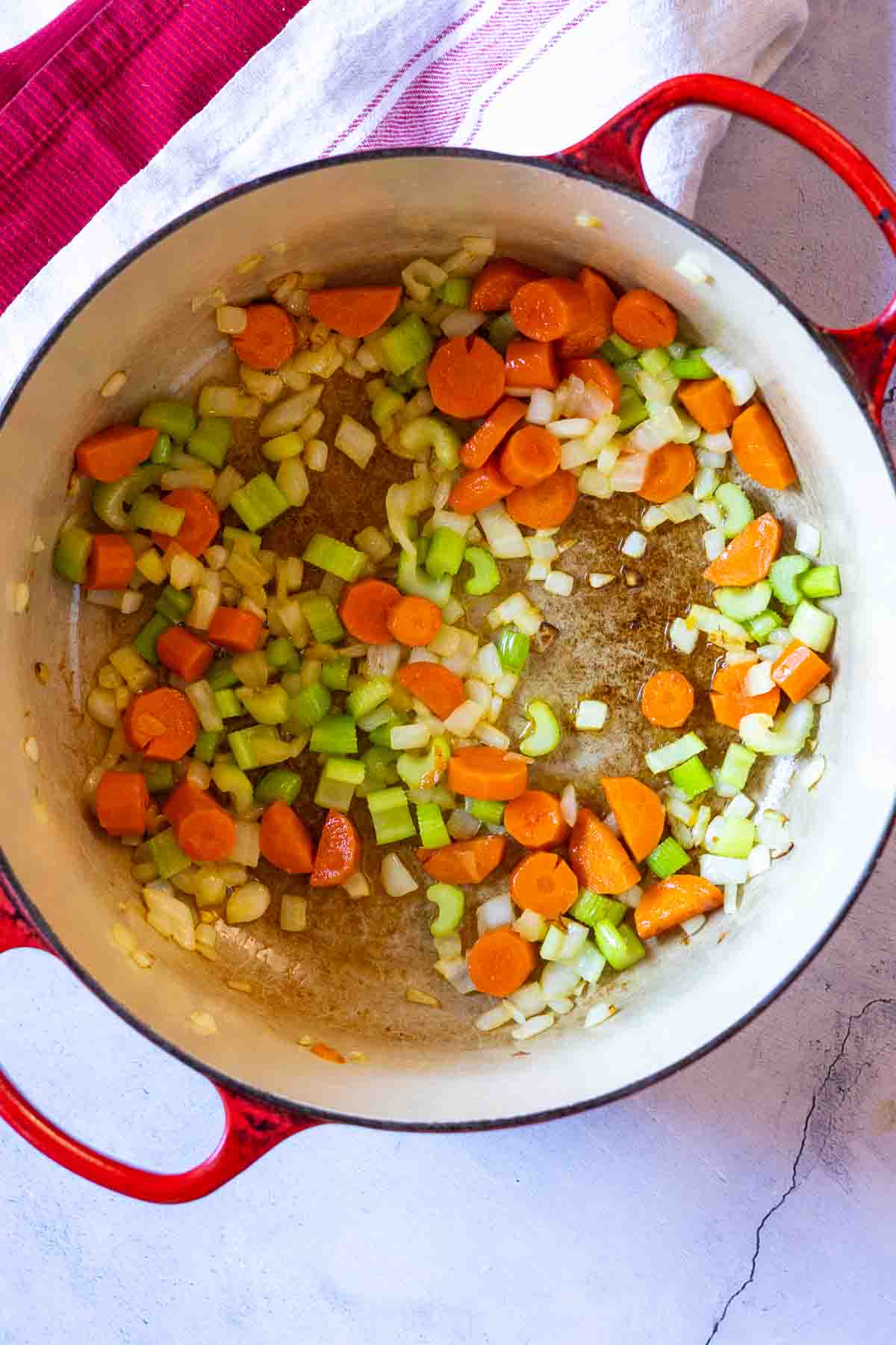 Cooking vegetables in Dutch oven to make mayocoba bean soup.