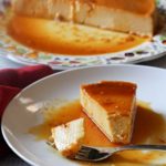 A slice of cream cheese flan with caramel sauce