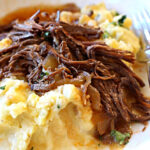 Beef brisket cooked in cola and bbq sauce and served over mashed potatoes