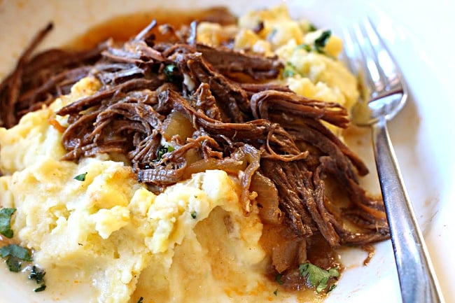 Beef brisket cooked in cola and bbq sauce and served over mashed potatoes
