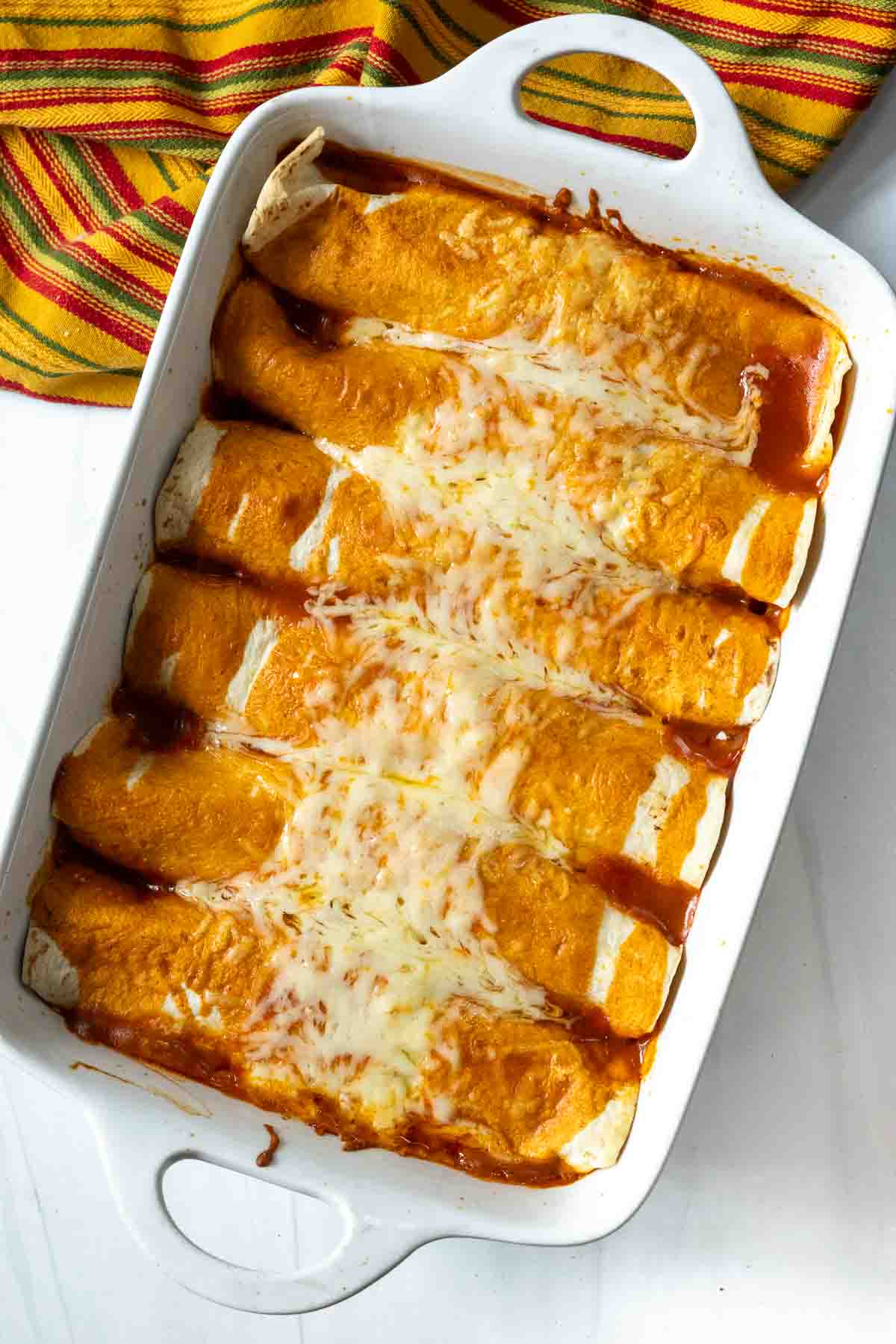 A casserole pan of Enchilada style burritos.