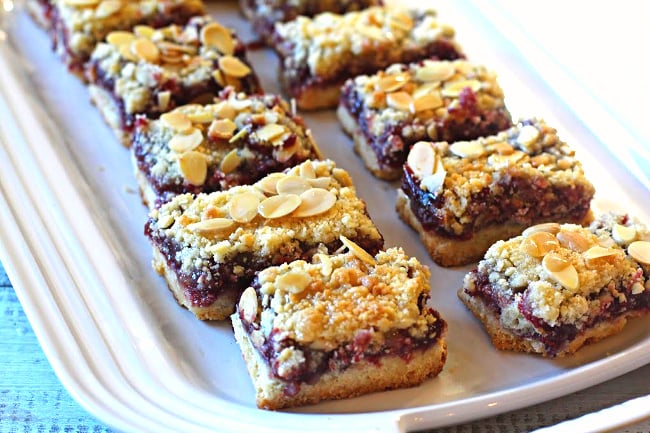 Almond Raspberry Bars made with raspberry jam on le creuset white platter