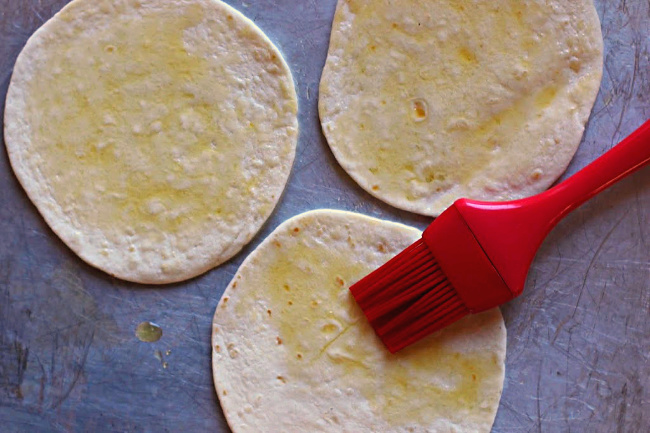 Tortilla Pizza appetizer, oiling the flour tortilla with a silicone brush