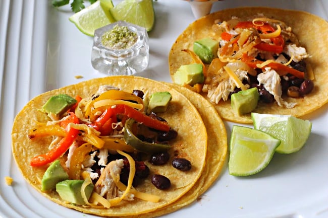 Roasted bell pepper tacos with black beans, chipotle chicken and cumin lime salt served on a le creuset white platter