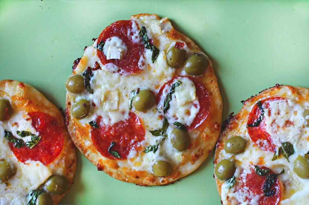 Flour tortilla pizza made with brie cheese, pepperoni and olives.