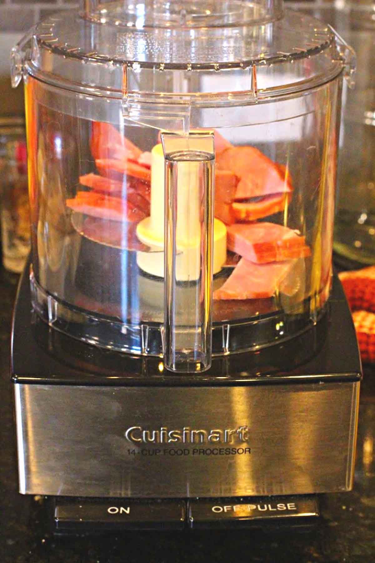 chopping ham in a food processor to make ham salad sandwiches