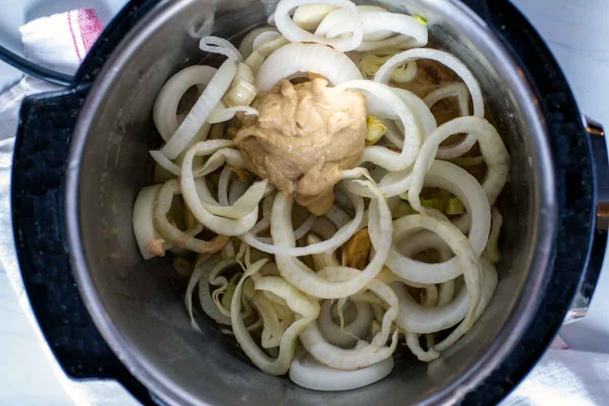 Cooking onions and fennel in the pressure cooker.