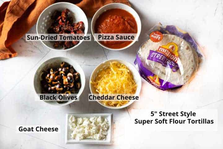 Ingredients to make flour tortilla pizzas.