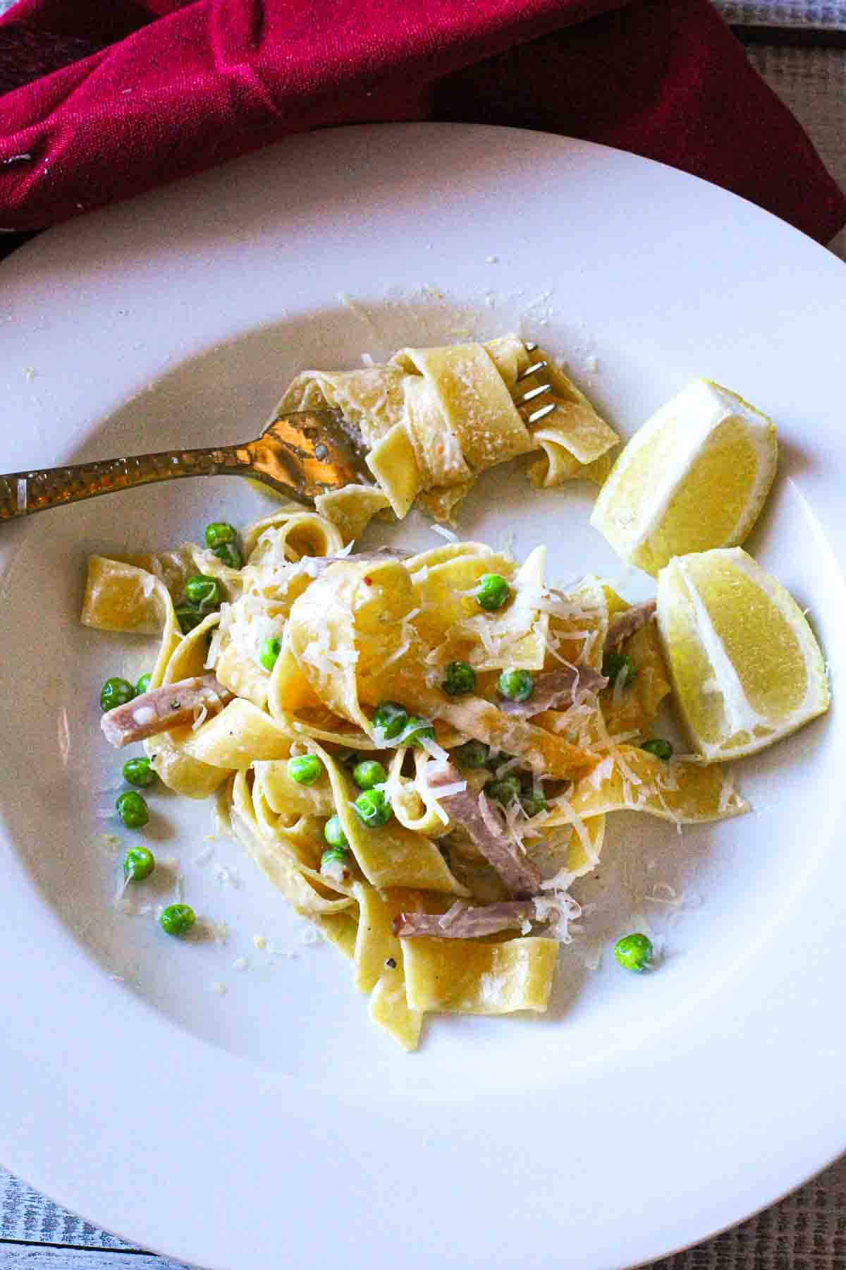 Pappardelle Pasta with ham and peas in a lemon cream sauce.