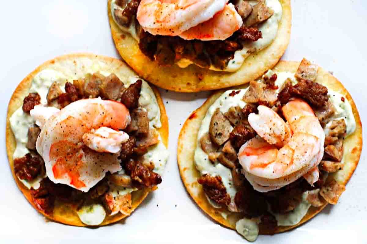 Flour tortilla pizza made with shrimp and andouille sausage.