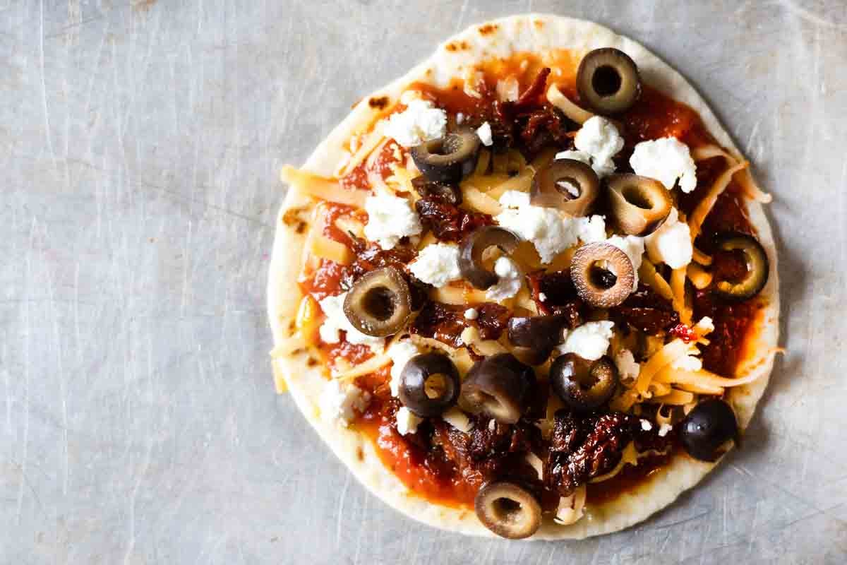 Step 5 to make flour tortilla pizzas.