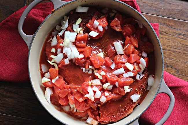 Ingredients for beef street tacos ready to bake in a Le Creuset Pan