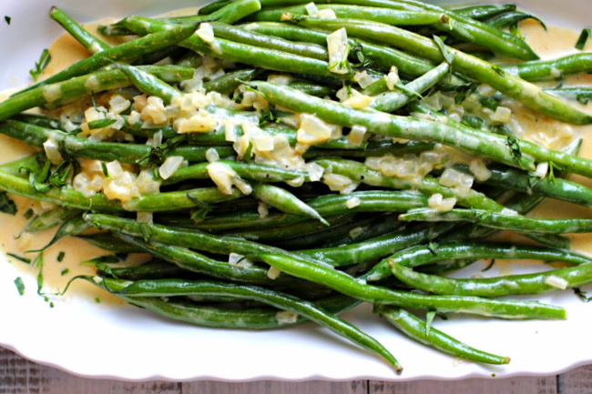 Green Beans or Hericot Verts in a Dijon sauce on a Sur la Table scalloped white platter