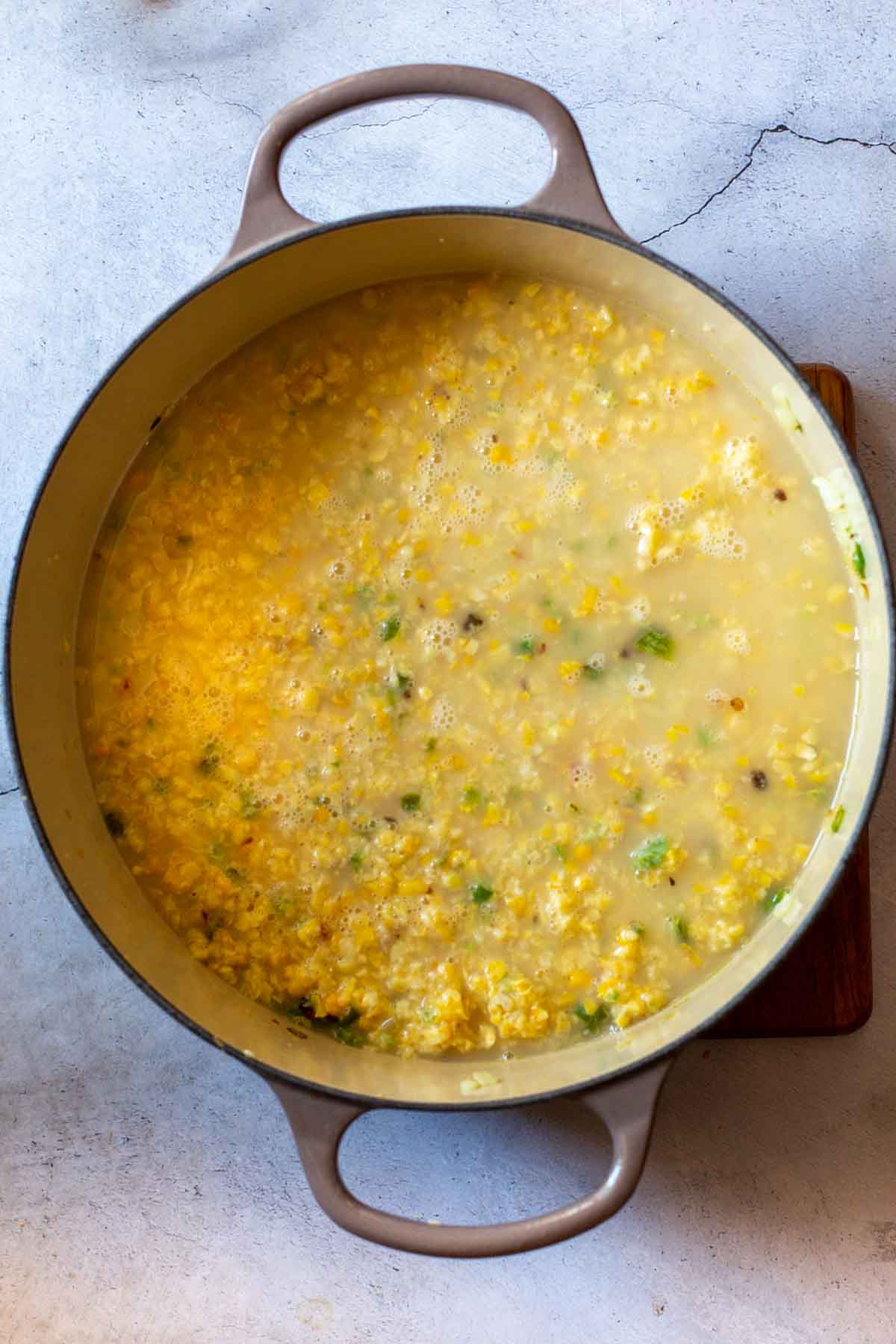 Cooking sweet corn soup in a Dutch oven.