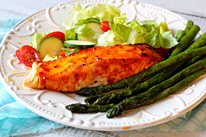 Farm raised salmon fillets baked with a peach jam glaze with a side of sauteed asparagus and a tossed salad