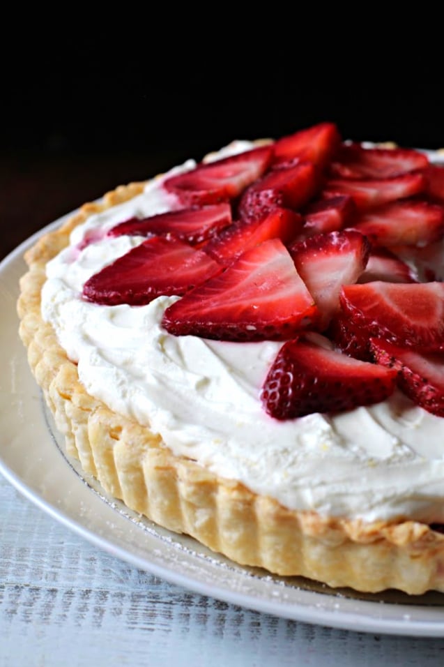 Strawberry Dessert Recipe with a tart crust in a tart shell topped with fresh strawberries and whipped cream