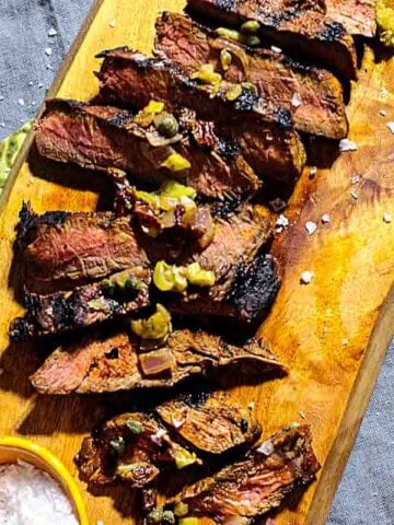Sliced grilled sirloin steak topped with caper relish.