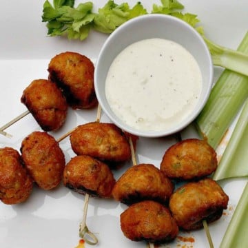 Chicken meatballs glazed in buffalo wing sauce served with blue cheese dressing and celery sticks.