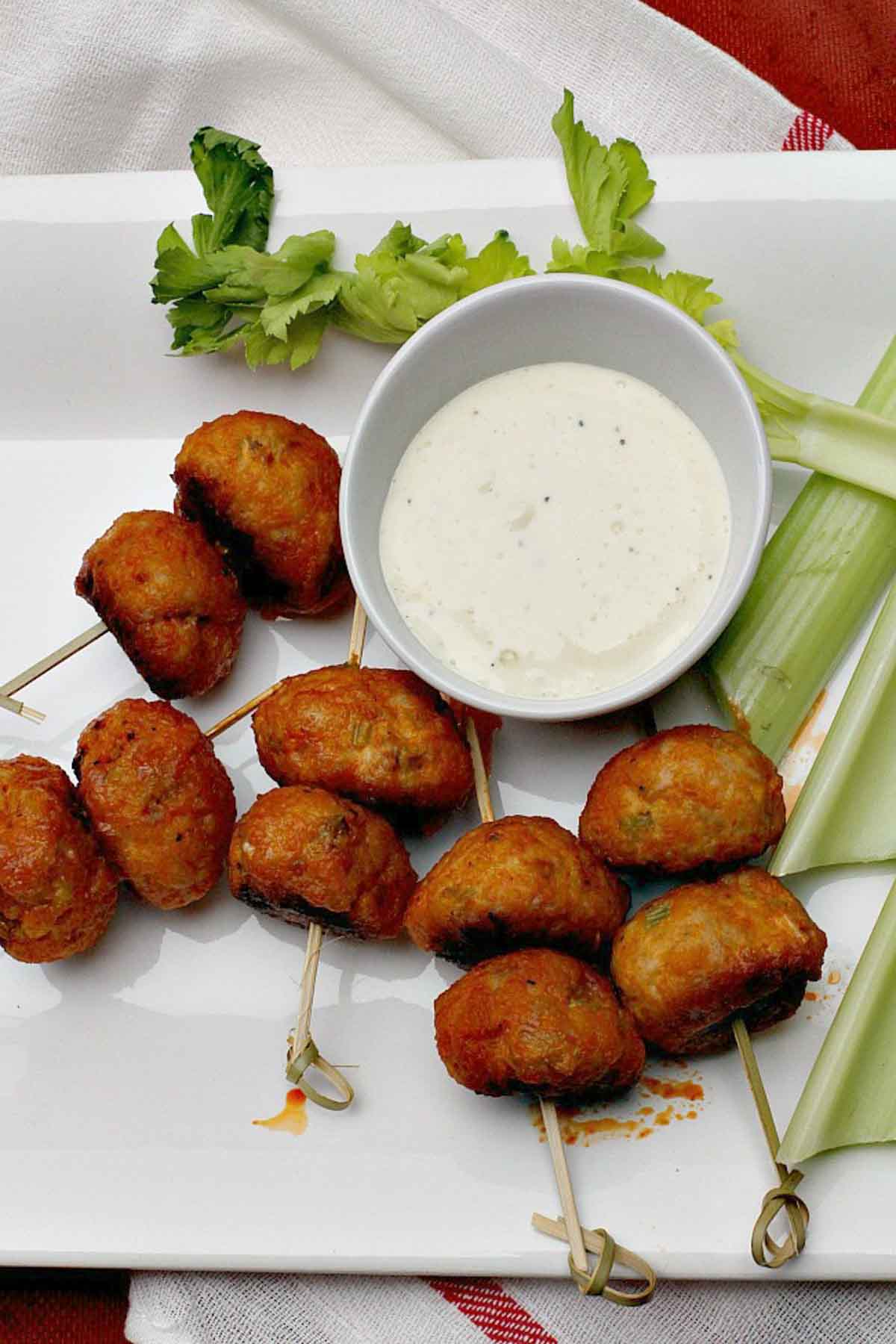 Chicken meatballs glazed in buffalo wing sauce served with blue cheese dressing and celery sticks.