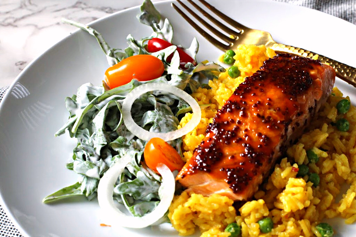 Salmon fillet glazed with maple and mustard served over Yellow rice with peas and a side salad tossed with buttermilk ranch dressing