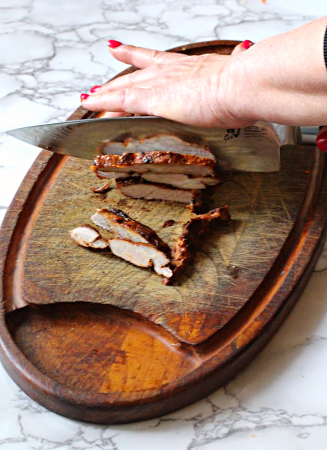 Pork steaks on a cutting board. How to cut pork steaks for tacos al pastor