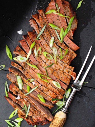 Grilled flank steak topped with sliced green onions