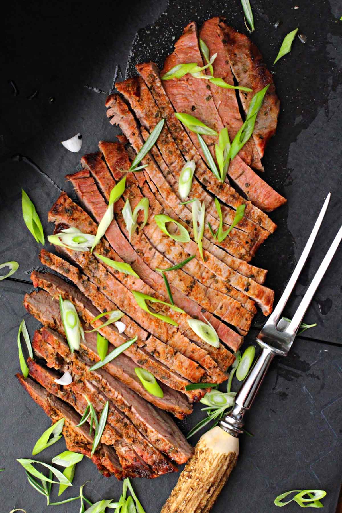 Grilled flank steak topped with sliced green onions