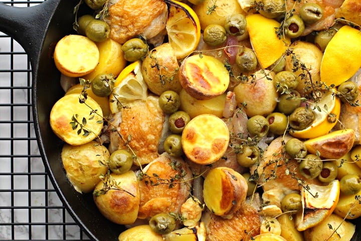 Cast Iron Skillet Chicken thighs with lemon, yukon gold potatoes, thyme, and olives. 