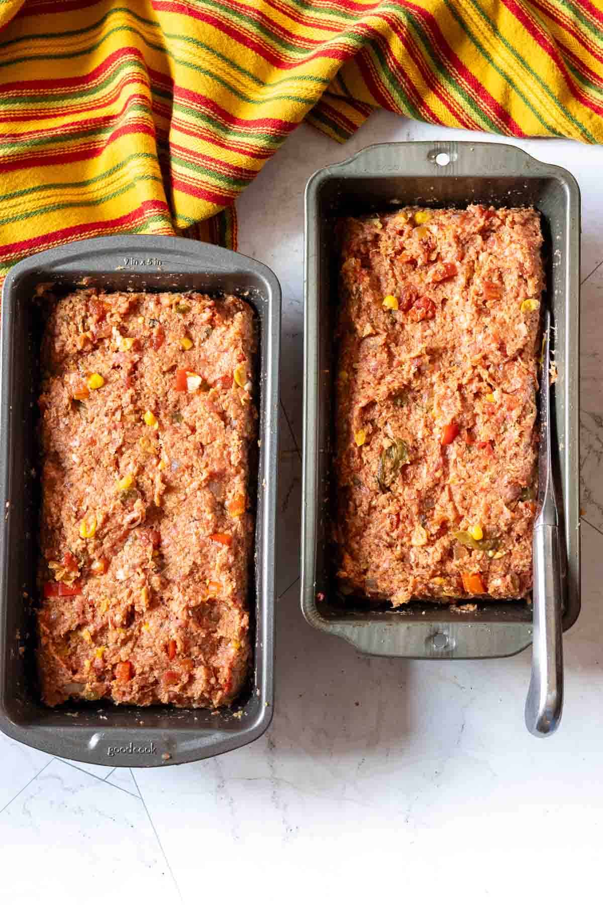 Forming spicy meatloaf into loaf pans, step 3.