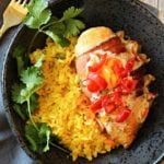Chicken breast wrapped in bacon topped with a tomato salsa served over yellow mexican rice
