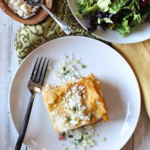 Green chile chicken lasagna served with a salad.