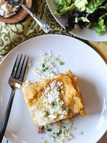 Green chile chicken lasagna served with a salad.